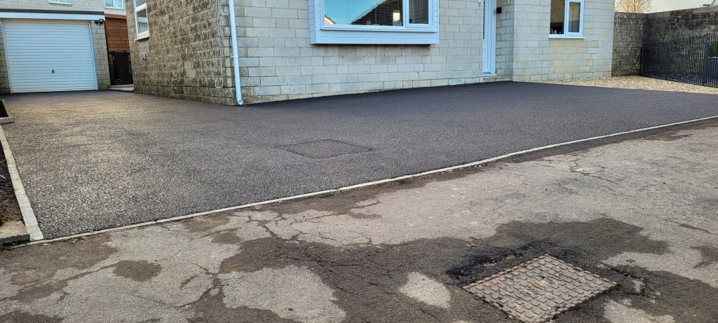 Tarmac driveway extension and overlay with infill drain cover in Westfield