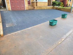 Tarmac driveway with sleepers and yellow lines in Midsomer Norton