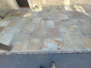 Reclaimed Yorkstone driveway with oak posts and cobble edging