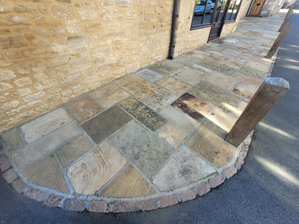 Reclaimed Yorkstone driveway with oak posts and cobble edging