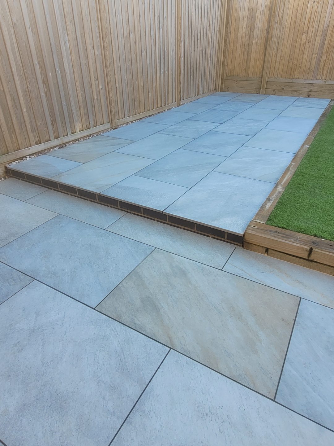 Grey porcelain tile patio with slimline aco drains and reduced steps in Midsomer Norton.