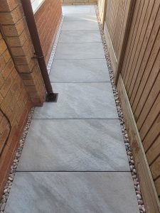 Grey porcelain tile patio with slimline aco drains and reduced steps in Midsomer Norton.