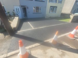 Tarmac driveway and drop kerb installation in Holcombe - Meticulously excavated and leveled with edging, providing a seamless transition from pavement to driveway for improved accessibility.